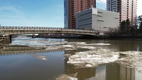 ice drifiting down river wilmington delaware winter drone slow left to right shot