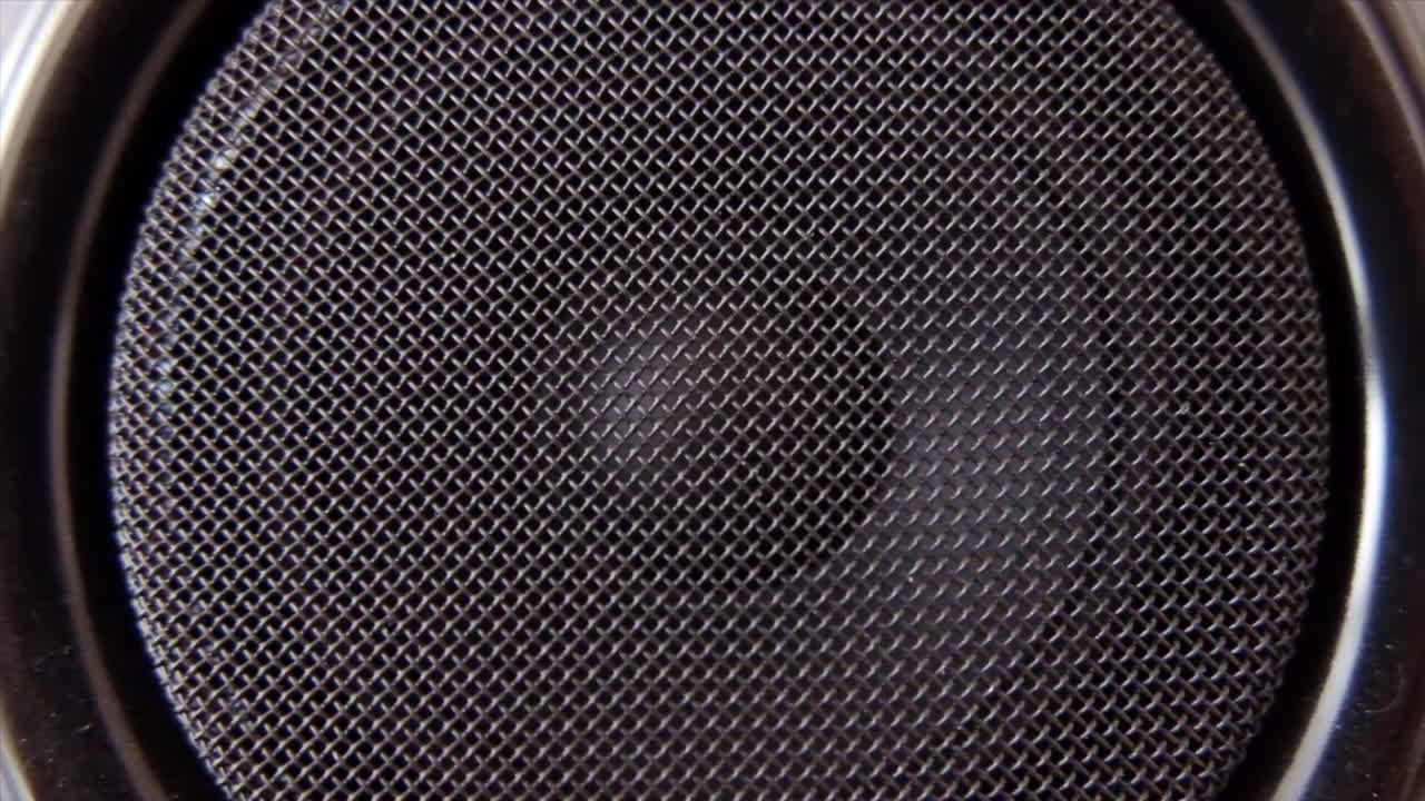 Close up of a speaker with a metal mesh covering