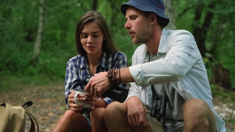 couple enjoying a drink in the forest