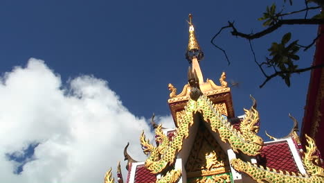 birds fly around the top of an ornate gold building