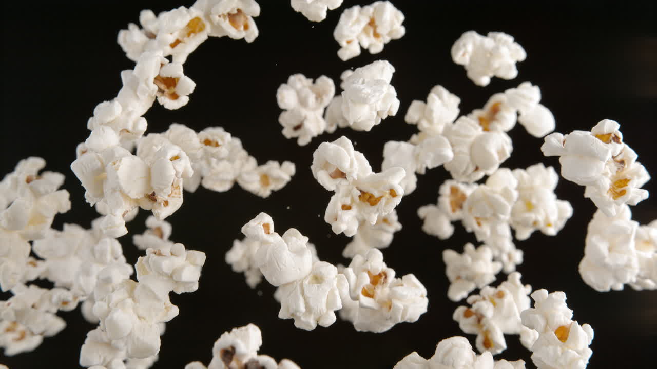 Popcorn Flying On The Black Background In Macro And Slow Motion