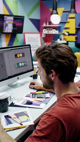 Creative Graphic Designer Working on Computer in Vibrant Office