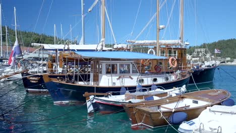 wooden sailboats and other boats in a harbor