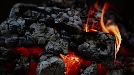 the close-up showcases the glowing charcoal, still aflame and radiating intense heat