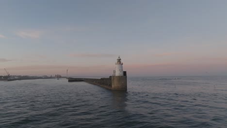 captivating drone footage of the lighthouse as it basks in the twilight