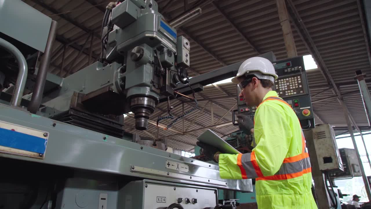Smart factory worker using machine in factory workshop