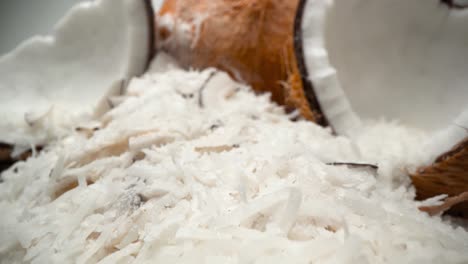 coconuts and shredded coconut flakes close up falling into tower ingredient pull away 4k food product video