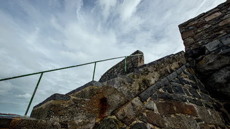 Time-lapse-of-old-and-aged-stone-stairs-with-railing-in-coastal-landscape