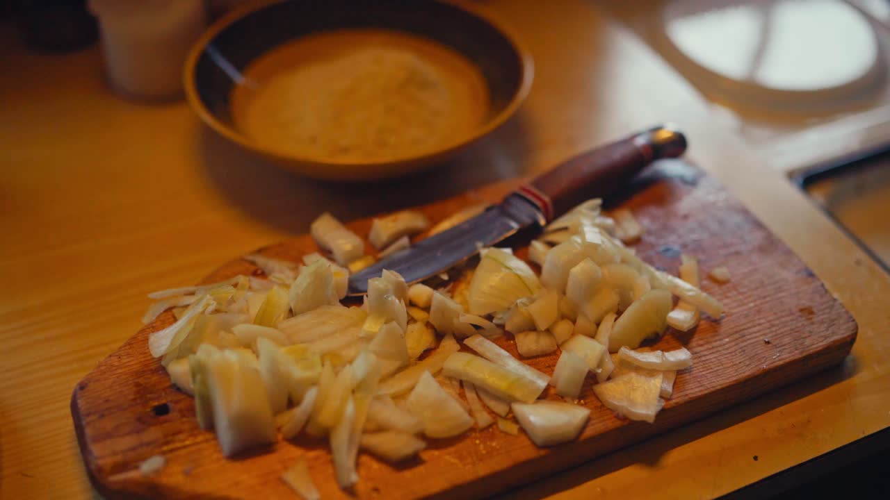 Chopped White Onions And Knife On Wooden Chopping Board. - closeup shot