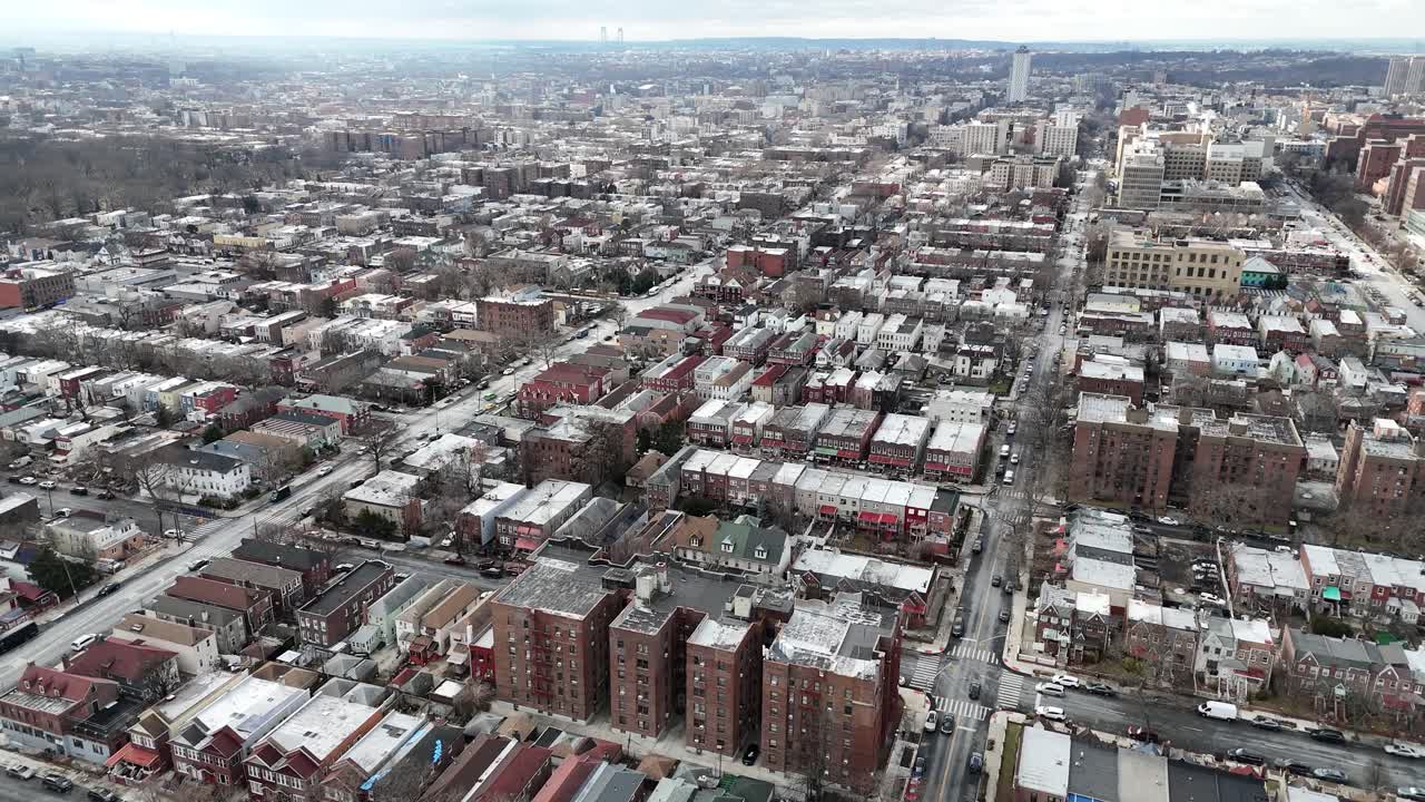 Horizontal drone circular-tracking shot over Troy Ave, Brooklyn, showcasing New York’s dynamic rooftops, vibrant streets, and urban charm from a smooth aerial rotation.