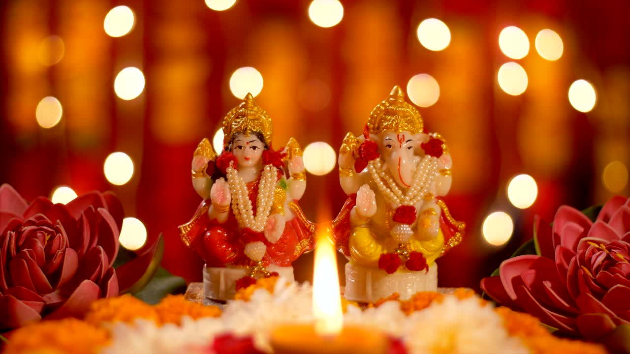 Diwali puja - Ganpati and Lakshmi Ji idol with diya lamp for pujan with bokeh effect