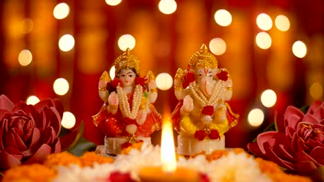 diwali puja - ganpati and lakshmi ji idol with diya lamp for pujan with bokeh effect