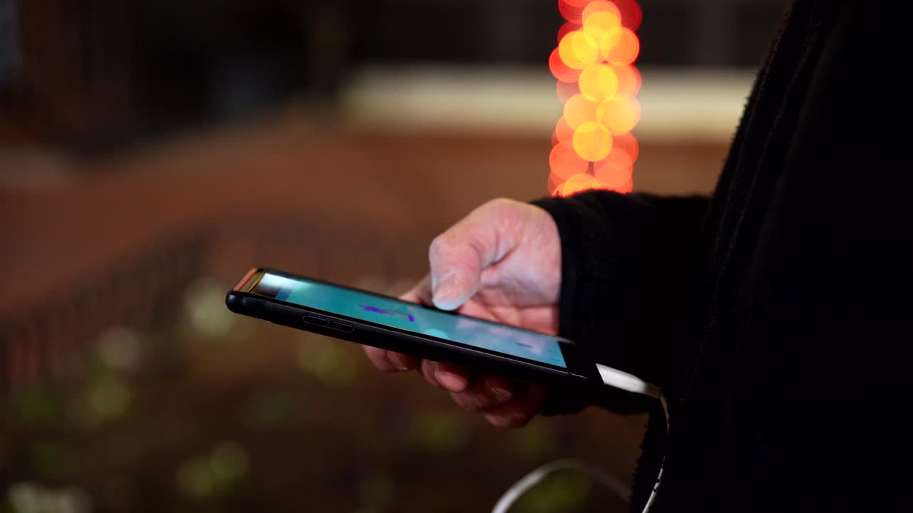 Man playing game on smartphone