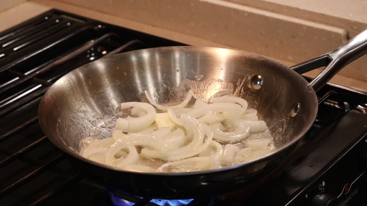 Butter melting in a saute pan of sliced onions
