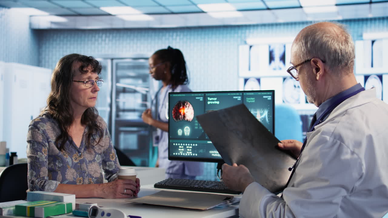 Vertical Video Oncology consultation takes place as a senior medic explains radiology scan