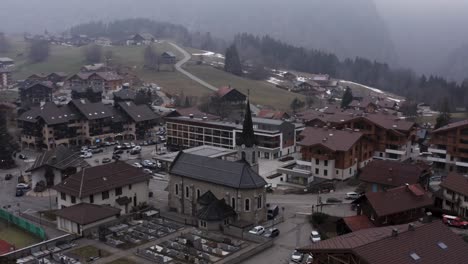 graveyard behind stone cathedral in alps