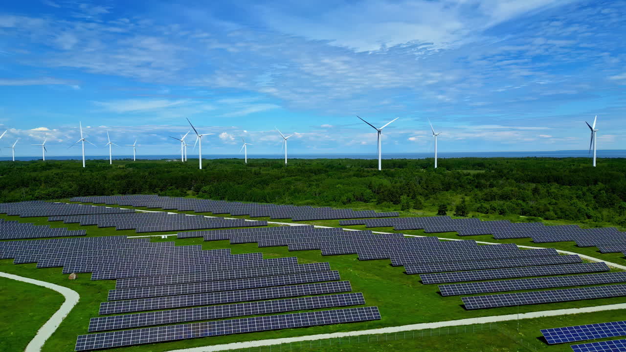 Solar Panels And Wind Turbines In Paldiski Wind Park In Estonia - Aerial Drone Shot