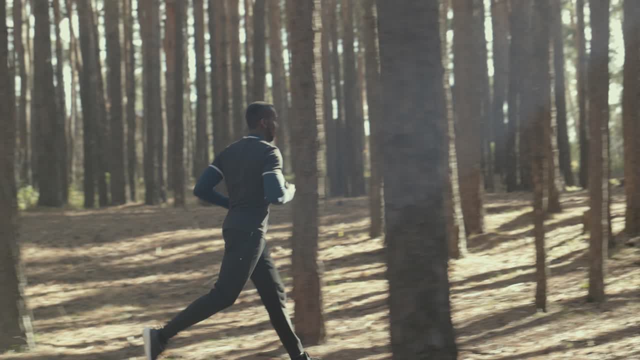 Man Running Through a Forest