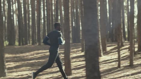 man running through a forest