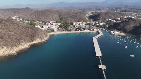 Sky-high-vista-of-Santa-Cruz-Bay-in-Huatulco,-Mexico,-designed-for-docking-cruise-ships-and-yachts