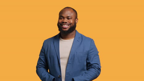 Portrait-of-cheerful-man-smiling,-looking-pleased,-studio-background