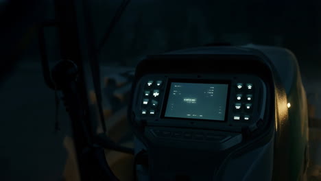 illuminated control panel and digital display in a vehicle at night