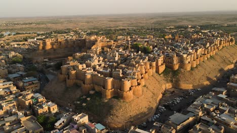 aerial drone shot of the fort's sandstone walls reflecting the fiery tones of a rajasthan sunset.