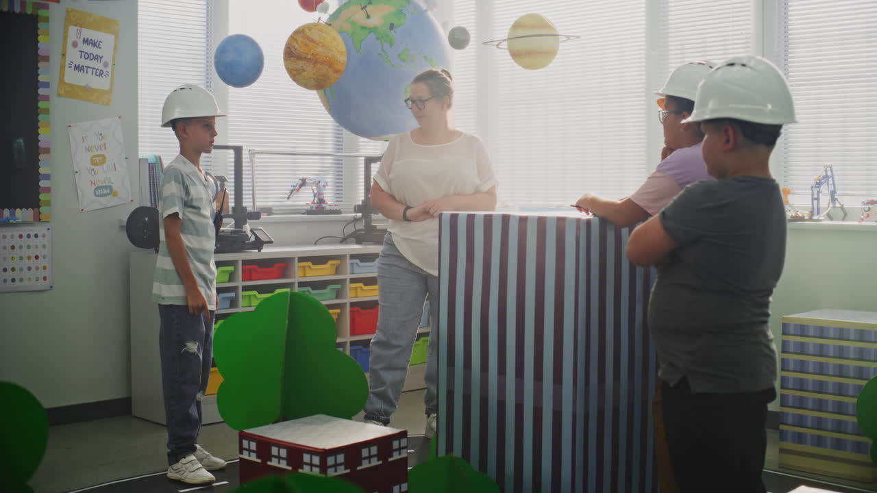 Team of Primary School Students in Hardhats Creating City Planning