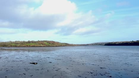 Aerial-drone-shot-flying-low-over-the-surface-of-the-River-Ilen-in-Cork,-Ireland