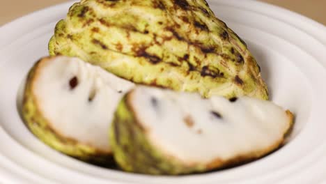 custard apple sliced and displayed on a plate