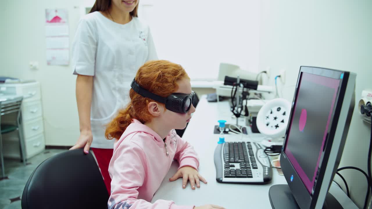 Programs on monitor to improve vision. Female ophthalmologist examining eyes of young girl