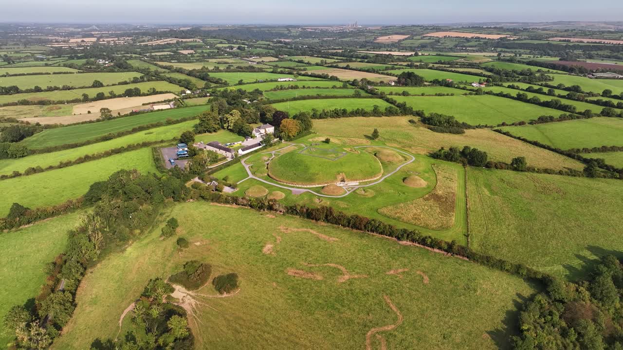 Aerial pull back from passage tomb entrance of Knowth megalithic monument, Ireland history