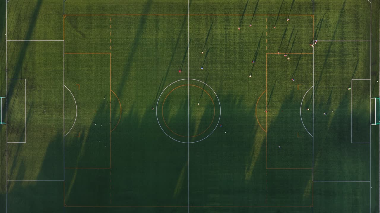 People on the soccer practice still drone with full field in view