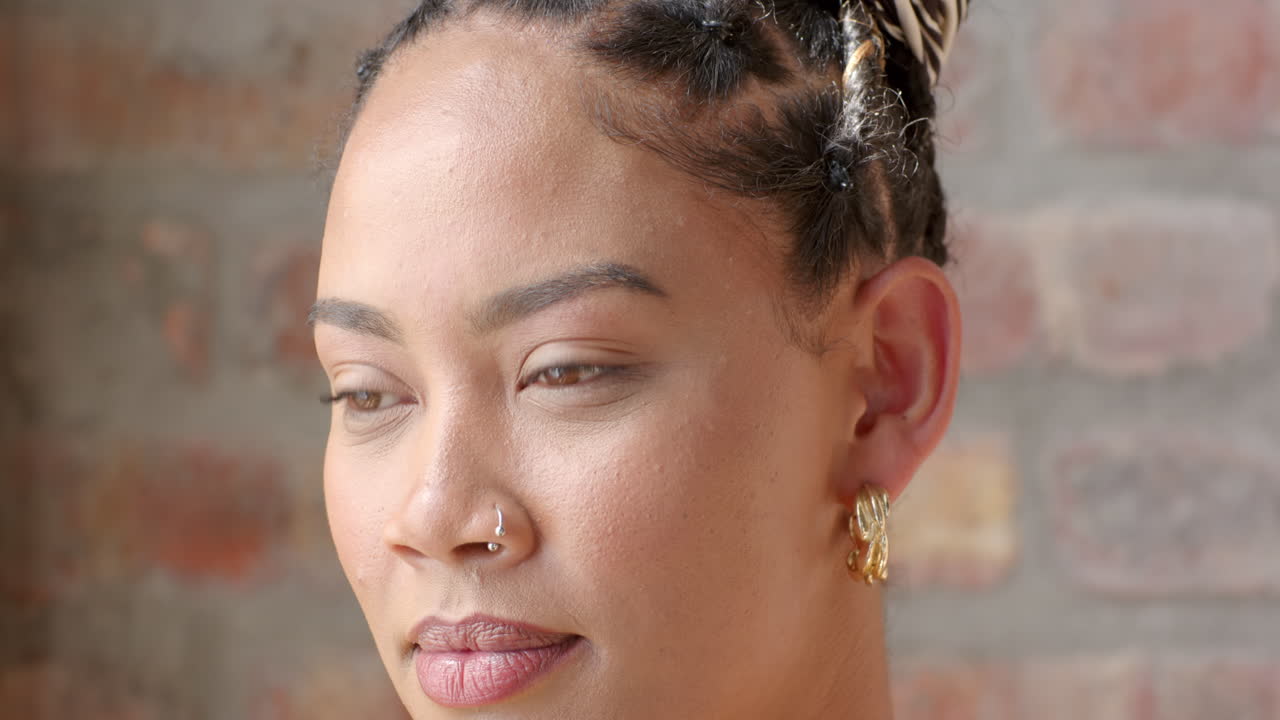 In office, woman focused on coding project, natural light highlighting face