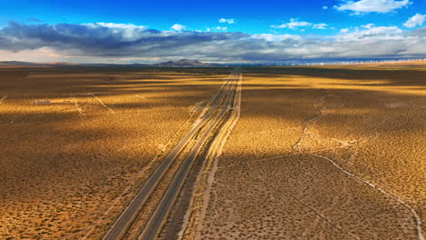 rare cars moving by the highways in the desert. beautiful landscape in the azure sky at backdrop.