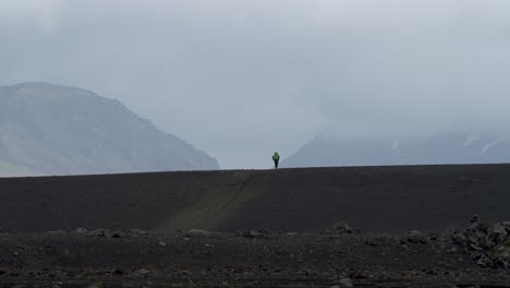 hiker on laugavegur trekking path in foggy and cloudy iceland island