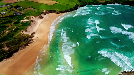 aerial drone shot over the picturesque rocky coastline in cornwall, united kingdom