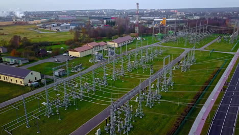 aerial drone rotating shot over a high voltage power distribution substation on a cloudy day