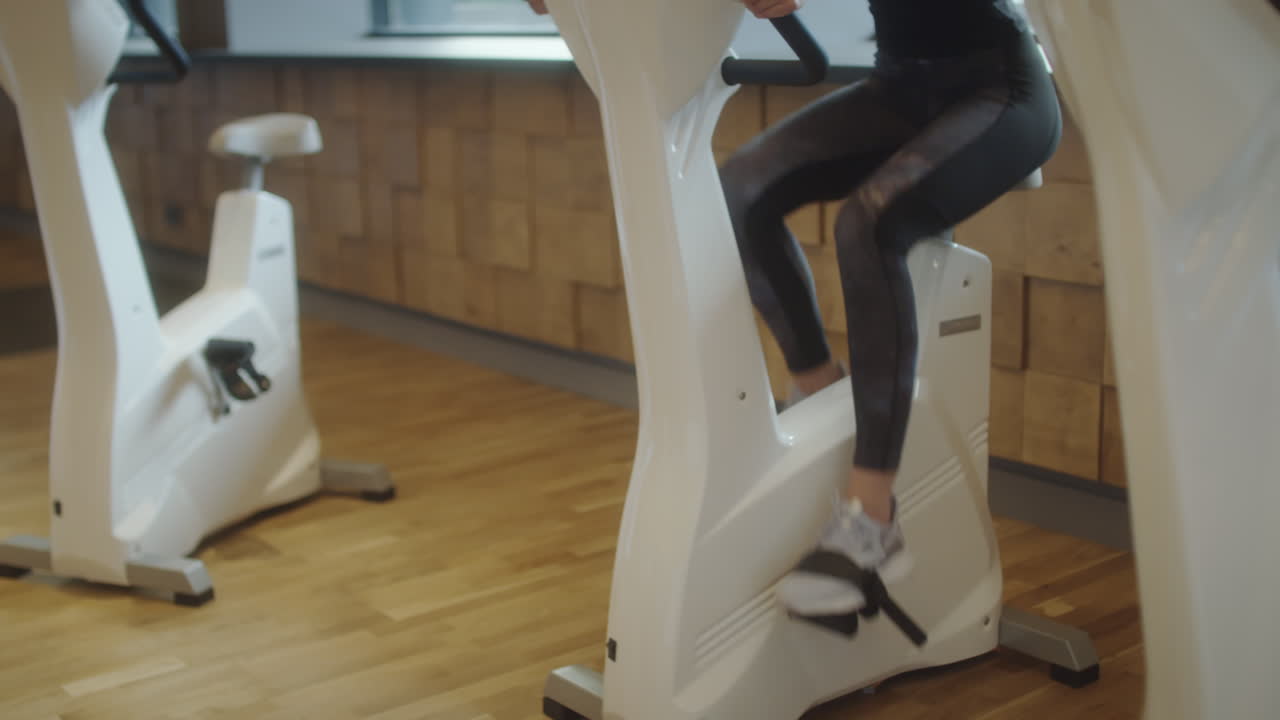 A person exercising on a stationary bike in a gym