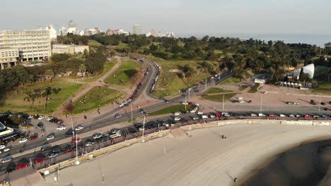 aerial shot of traffic in the park and the beach located in montevideo uruguay