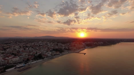 aerial scene of coastal town at sunrise nea kallikratia greece