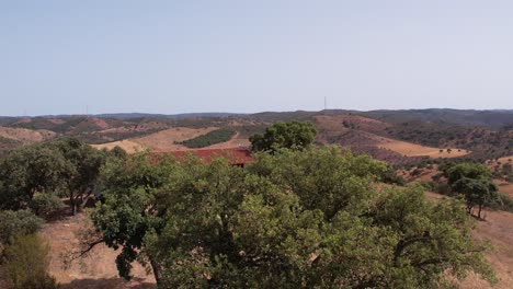 Aerial-view-Revealing-farmhouse-at-rural-landscape,-Alentejo