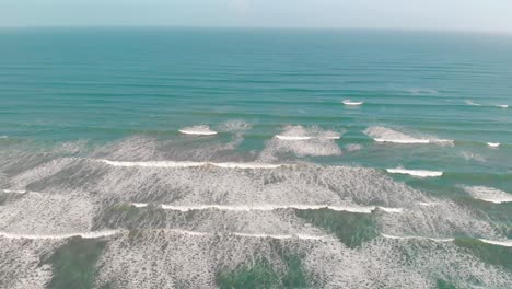 Slow-Motion-Shot-Over-Beautiful-Small-Waves-In-Peaceful-Blue-Ocean