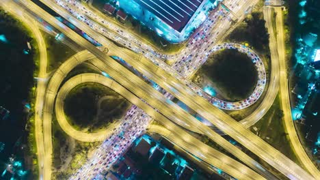 time-lapse or hyper-lapse aerial view highway road roundabout circle or intersection traffic at night for transportation concept.