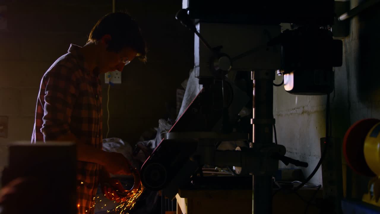 Female metalsmith using sharpening machine 4k