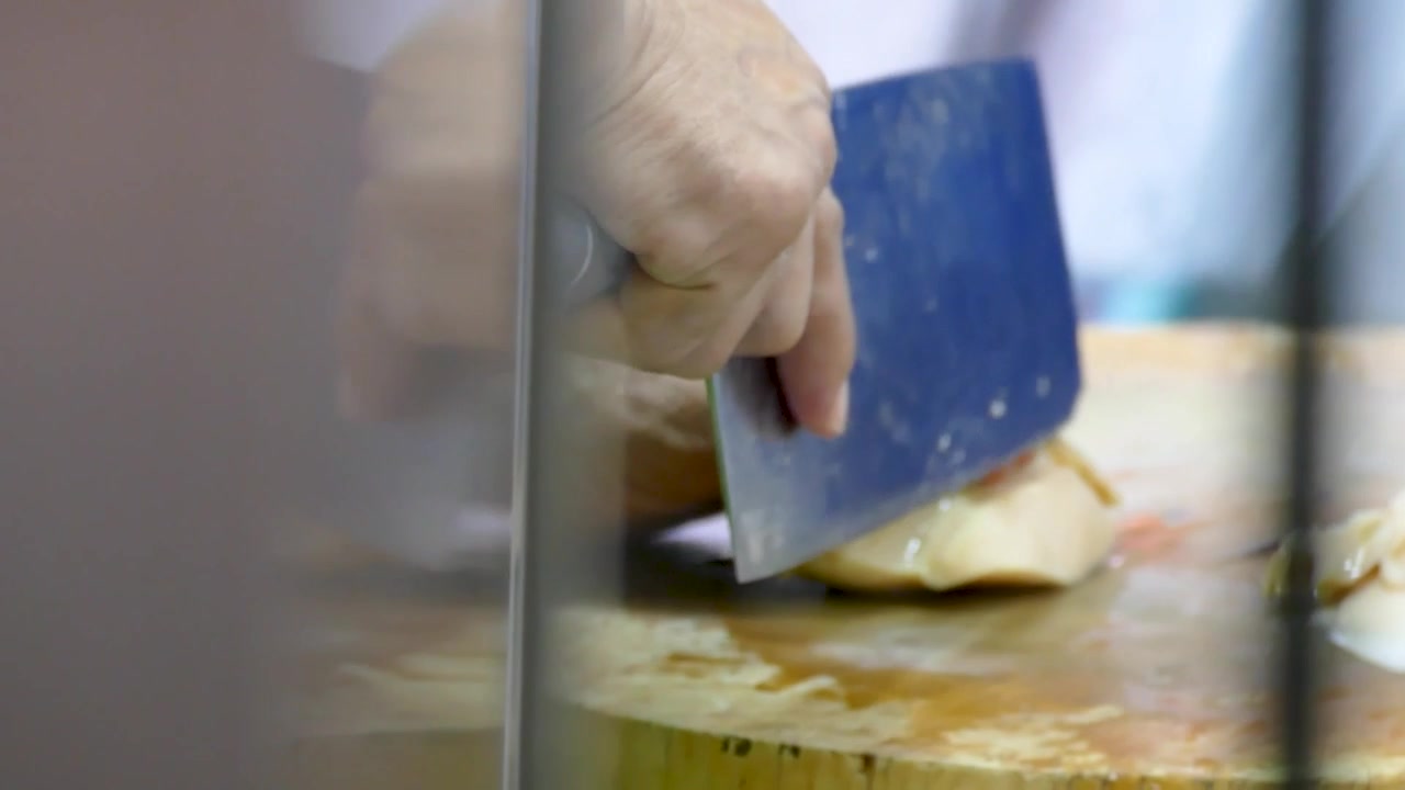 Asian Man Cut Fresh Abalone into Pieces, Close Up
