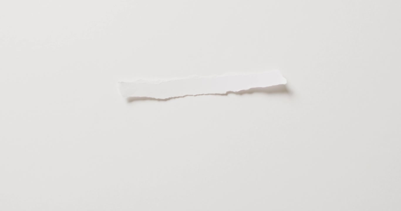 Video of close up of torn piece of paper with copy space on white background