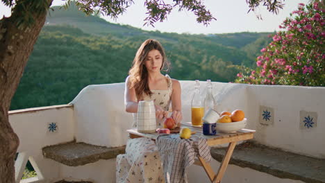 village woman cut apple open air breakfast. romantic girl preparing fruits salad