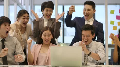 happy diverse casual creative business team are working hard to complete a business deal. they celebrate when they discover that they have been successful.