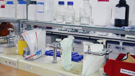 laboratory equipment and chemicals on shelves and workbench